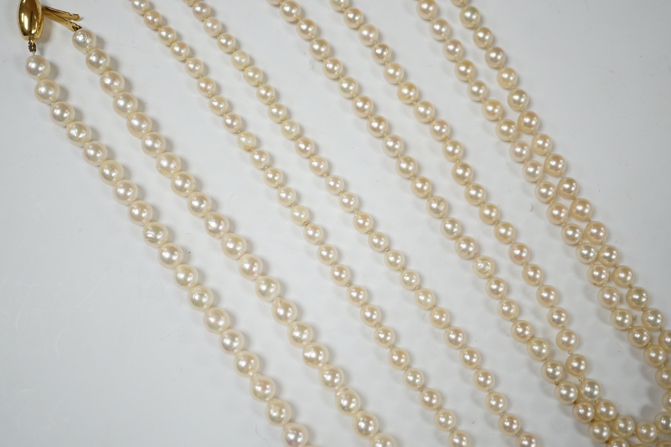 Three assorted modern single strand cultured pearl necklaces, one with 585 clasp, longest 76cm.